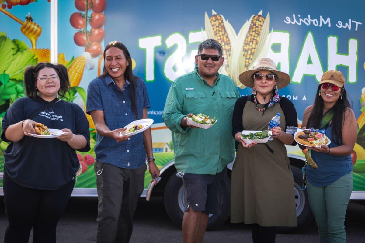 Five people standing in front of Harvest Food Hub Truck